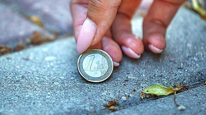 Pièces de monnaie éparpillées sur une table avec des bougies